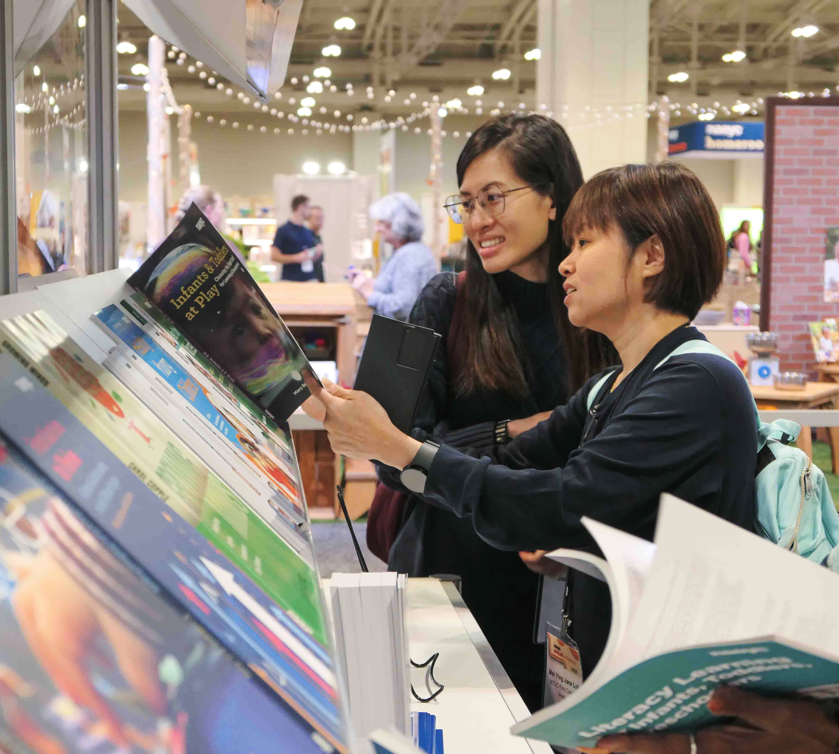 Two NAEYC members reviewing educational tools