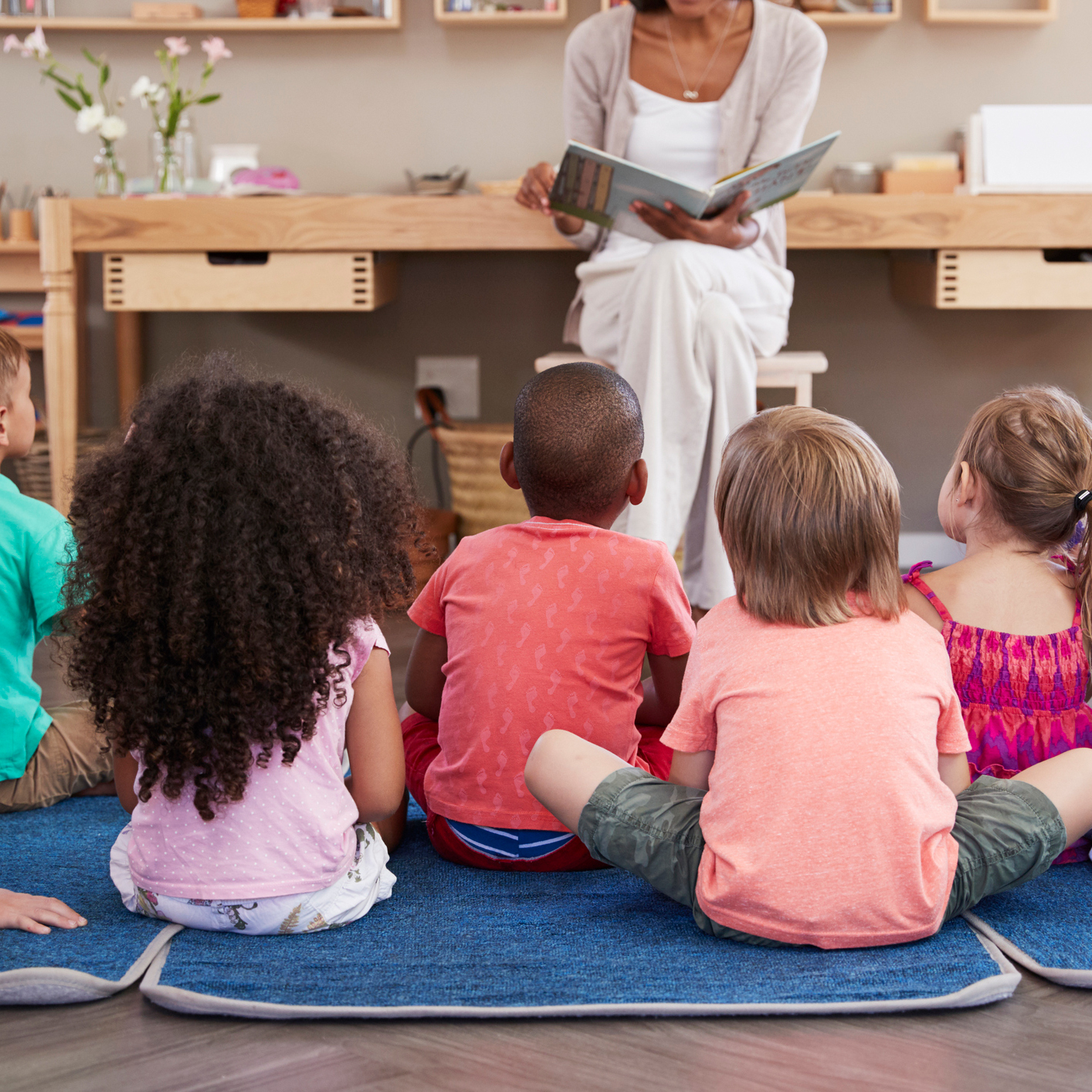 Teacher reading to a group of students