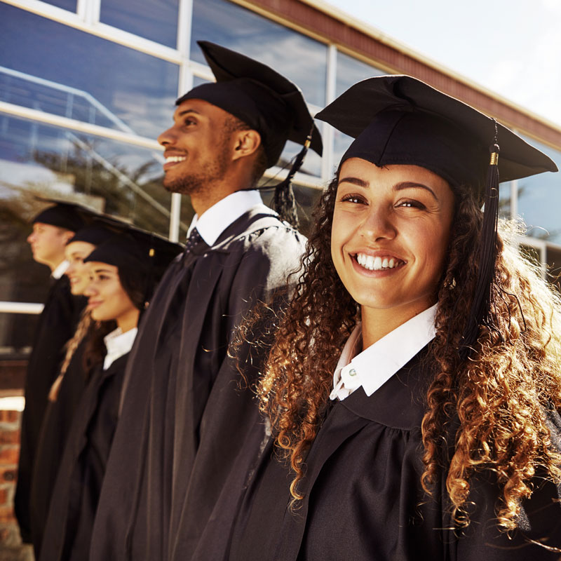 College graduates standing in caps and gowns