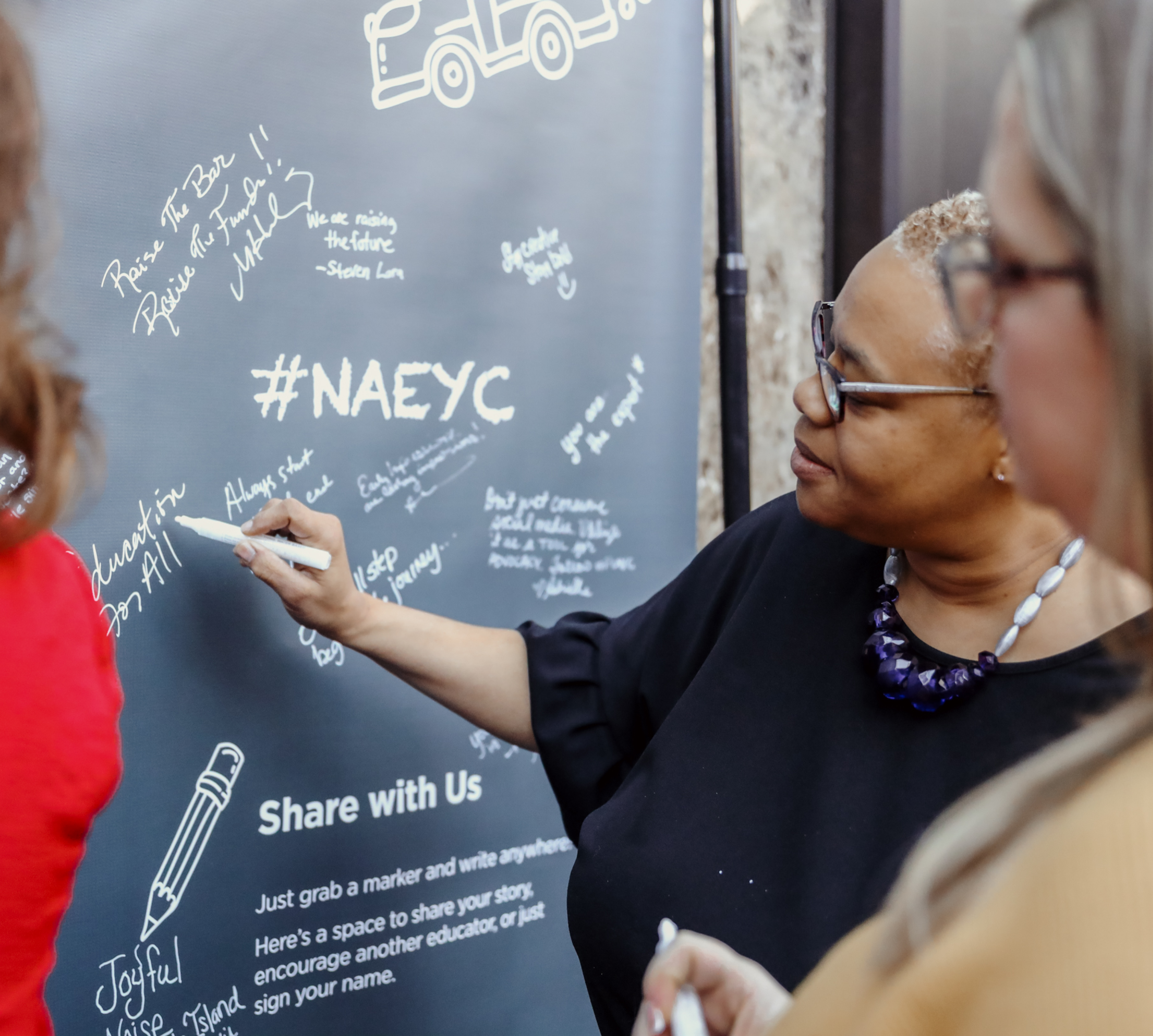 Woman writing on a chalkboard