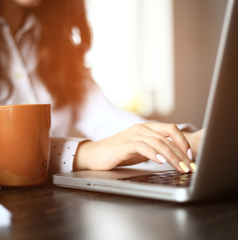 Woman typing on a laptop