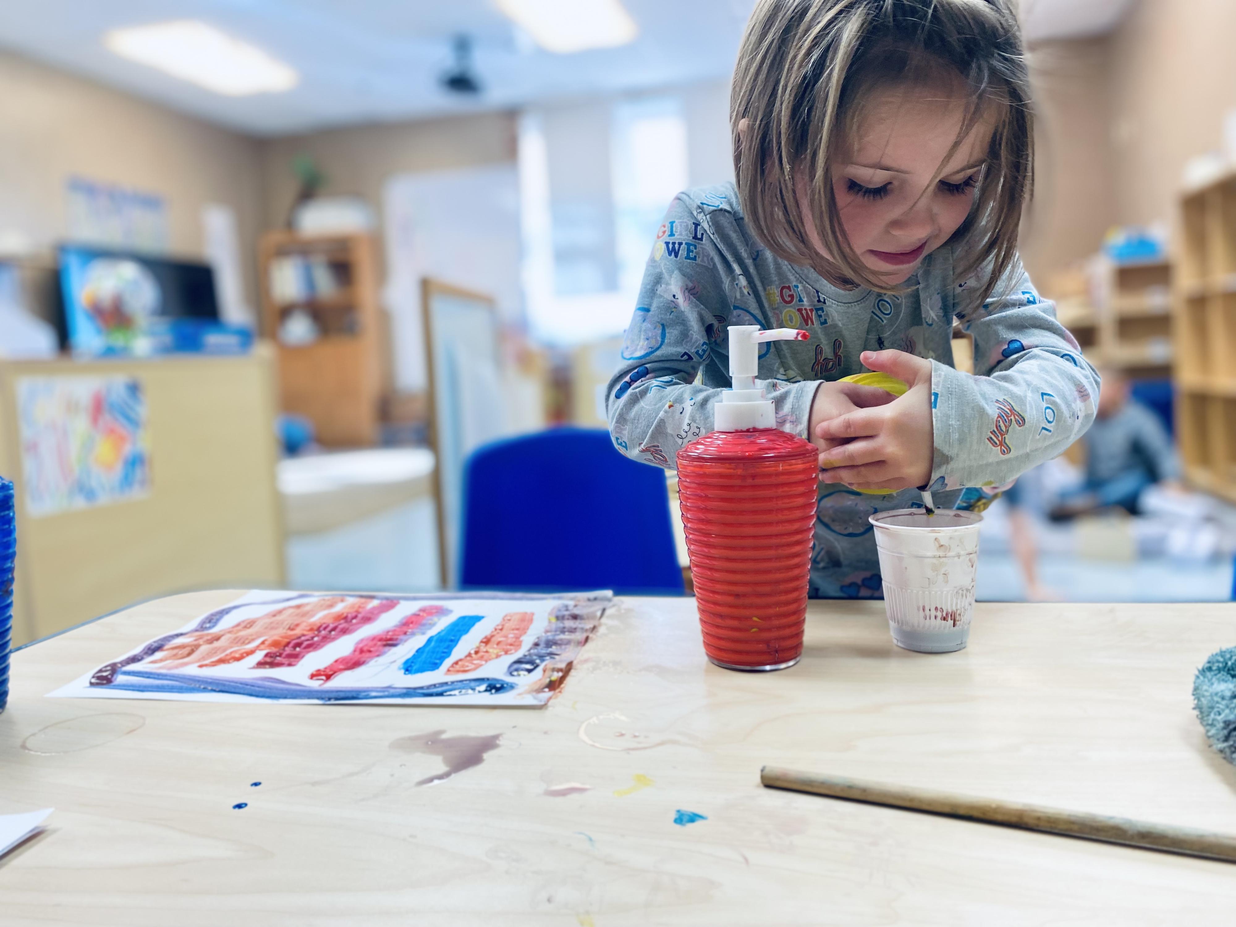 A five-year-old girl is working on her art project.