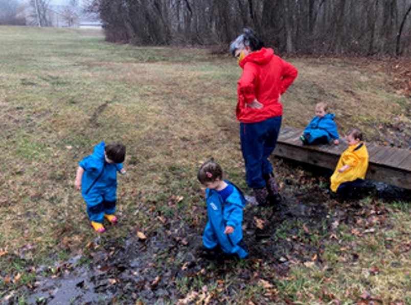 Toddlers wade into the stream.