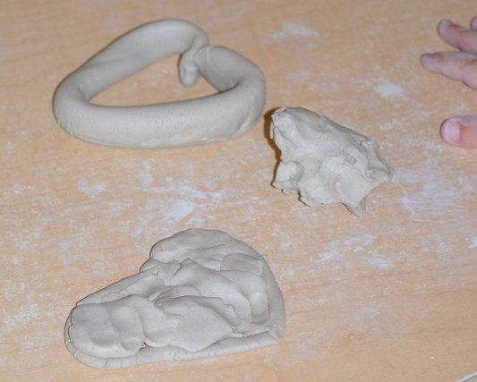 a childs hands playing with clay