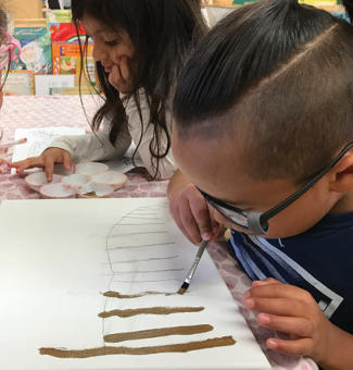 Zahid paints a border fence.