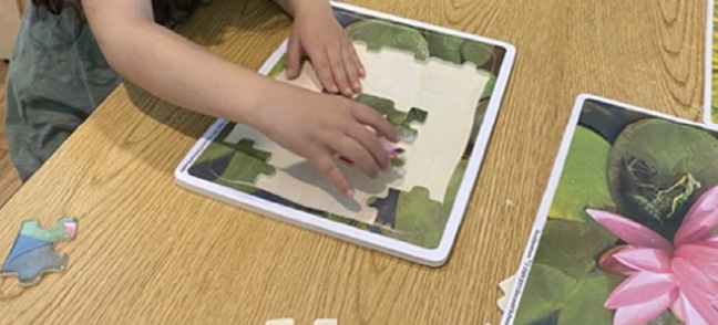 A child works on a puzzle.