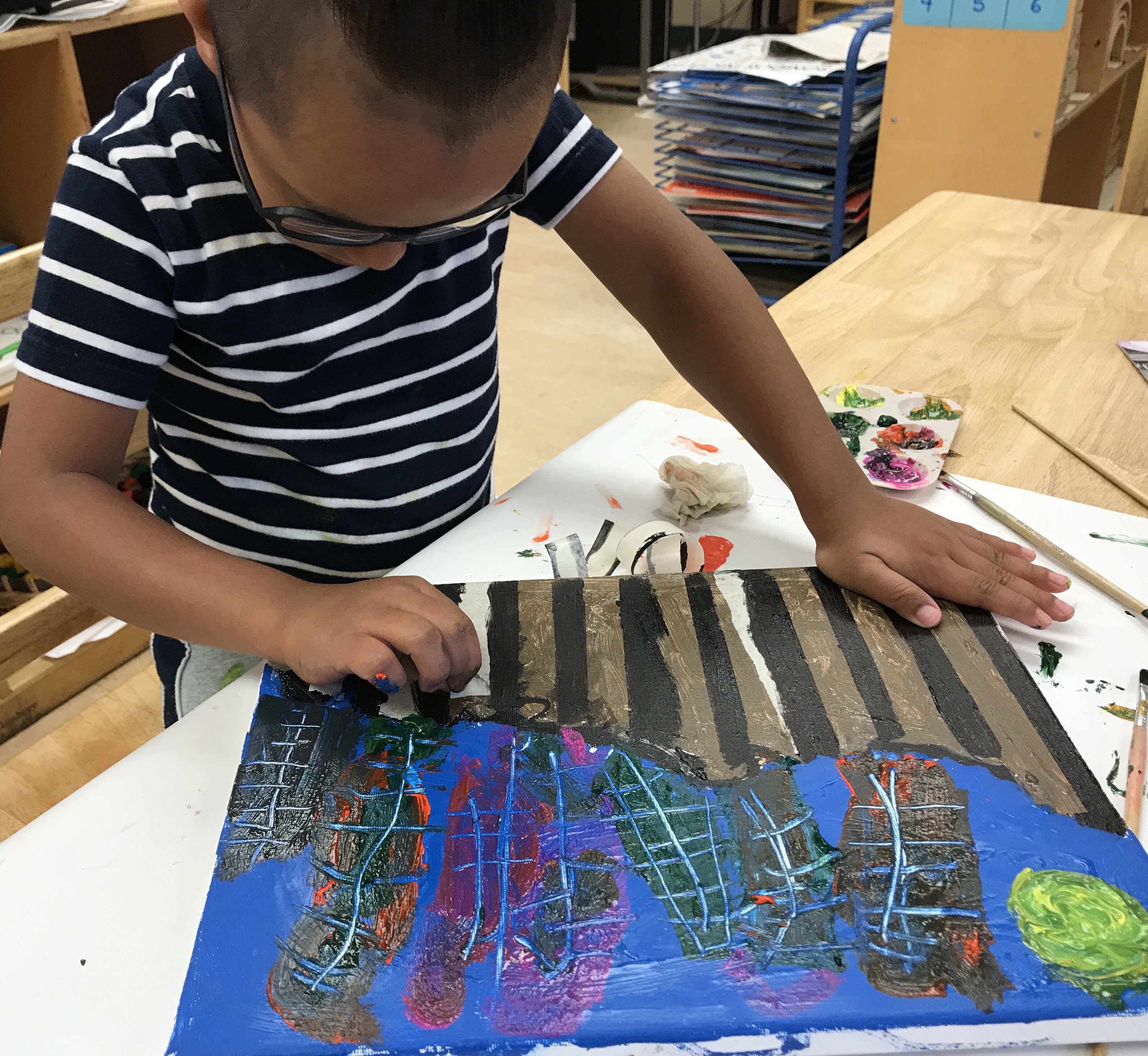 Zahid carefully crafts his picture of the border that separates him from his dad.