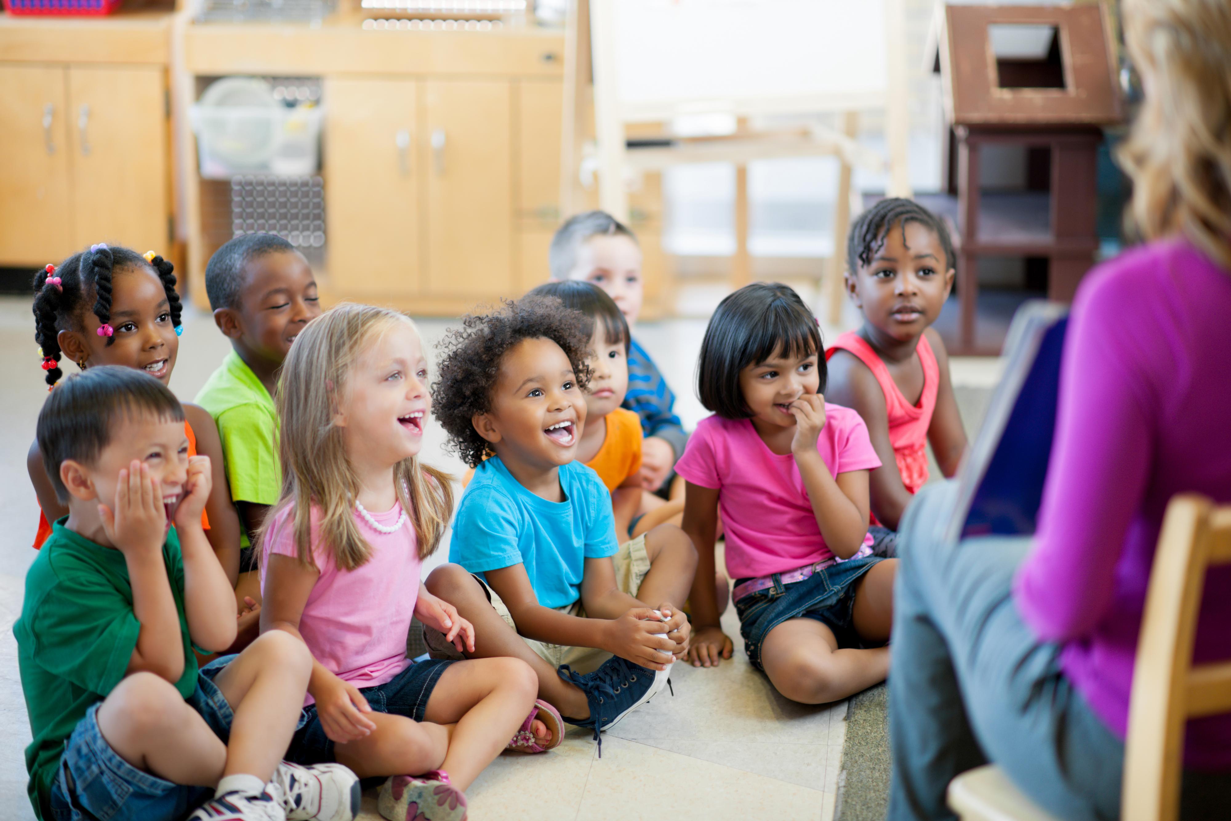 Children interact with their teacher during large-group time.