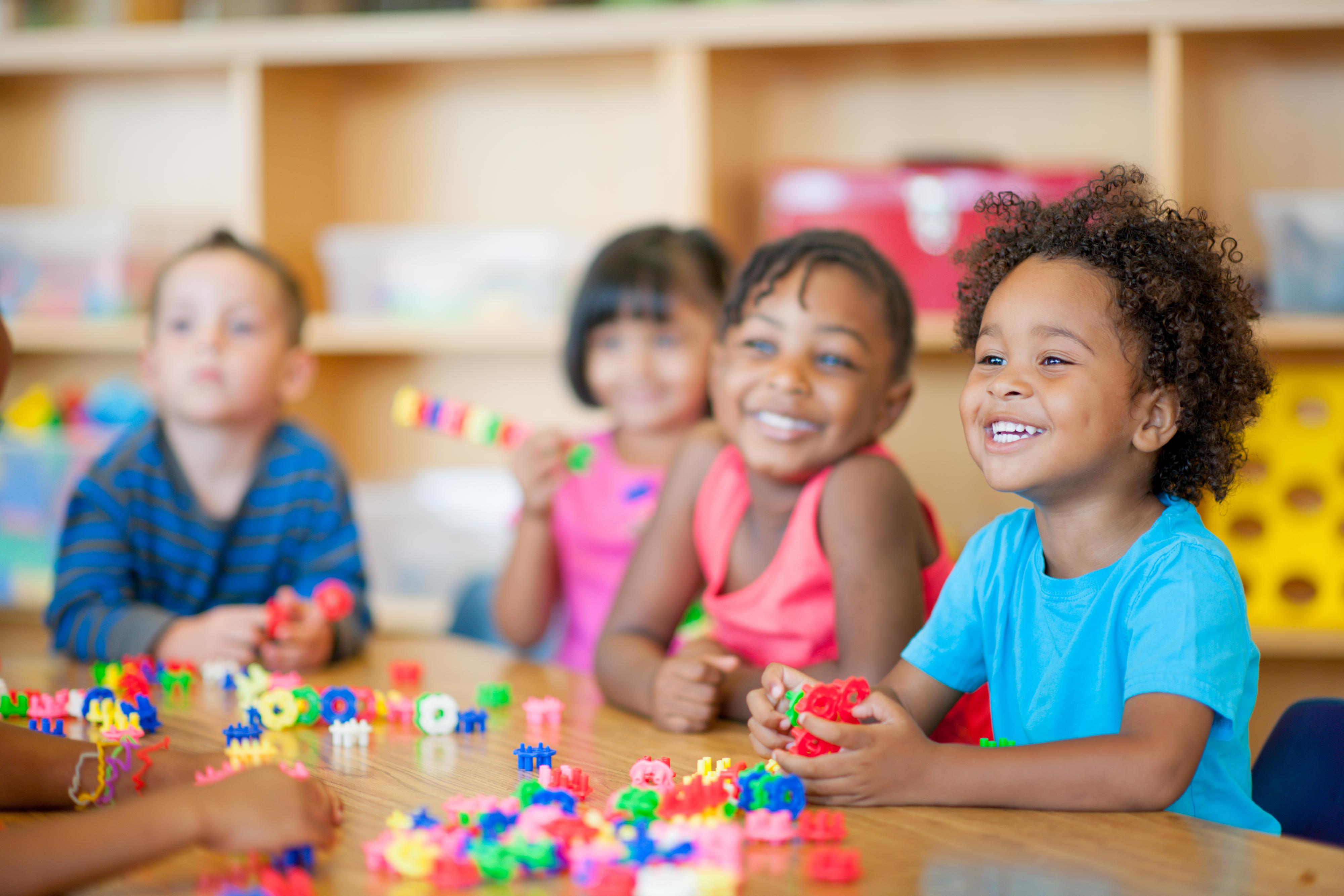 Children extend their curiosity as they play with manipulatives.