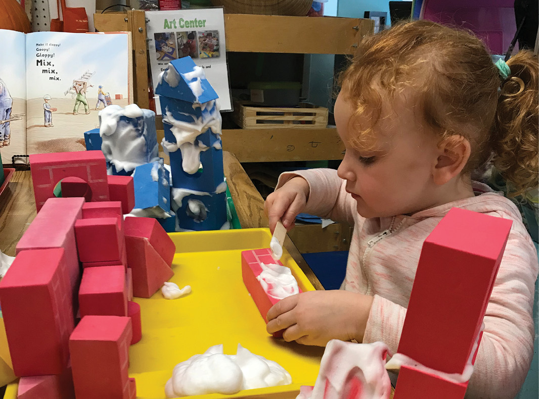 Child building with red blocks