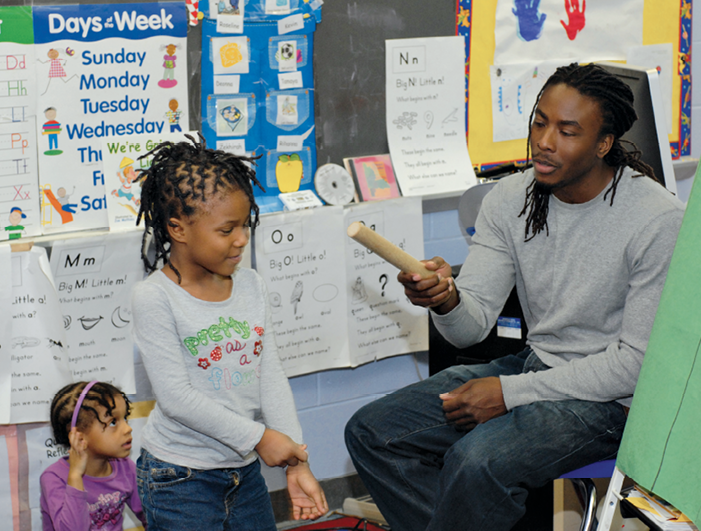 Teacher talking to students in classroom