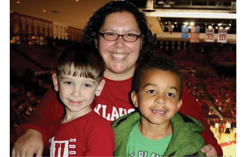 Francisca Jensen with two of her students at a basketball game