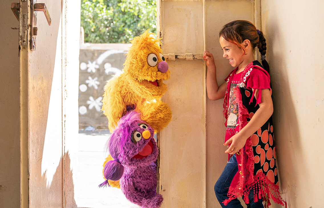 young Syrian girl with Muppets