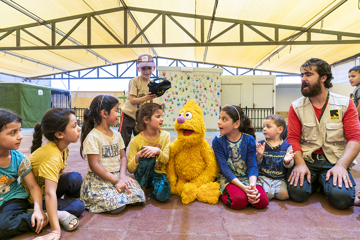 Syrian school children interacting with Muppet