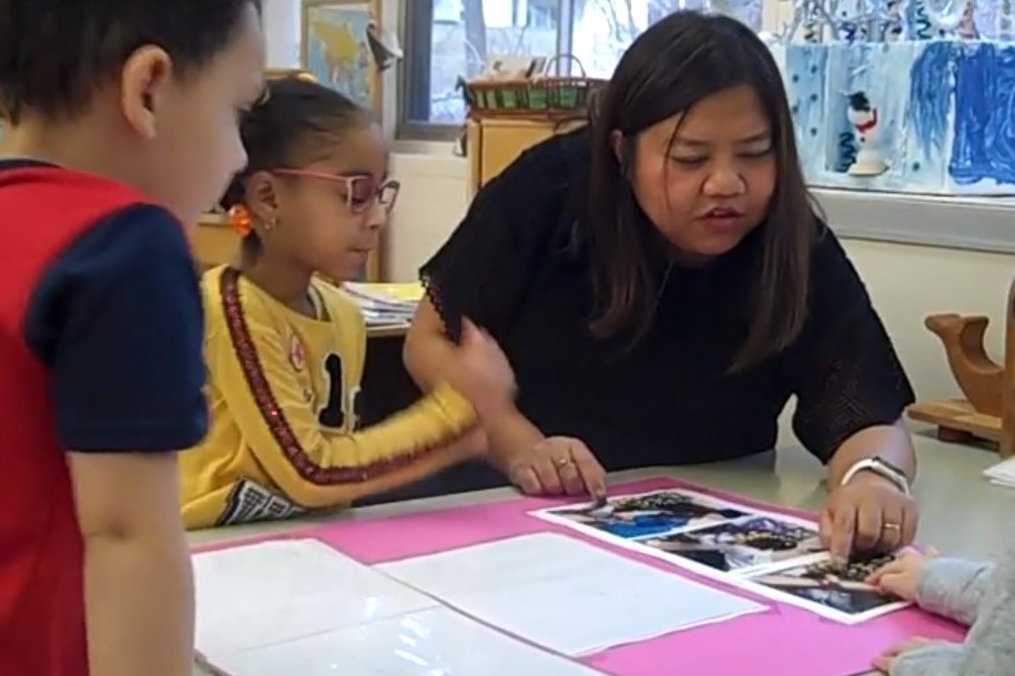 Suchira, a teacher in a Head Start program, works with a small group of children.