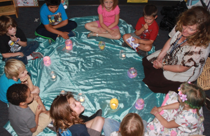 Children use electric candles to illustrate how their differences make each of them shine.