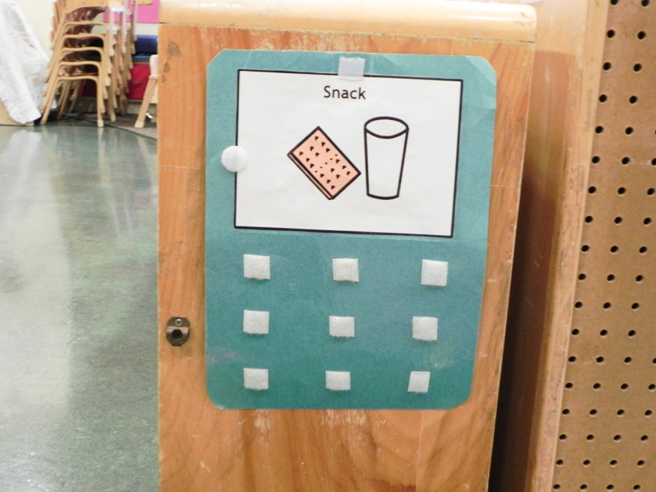 A velcro poster featuring the graphic "snack" with a glass of milk and a graham cracker