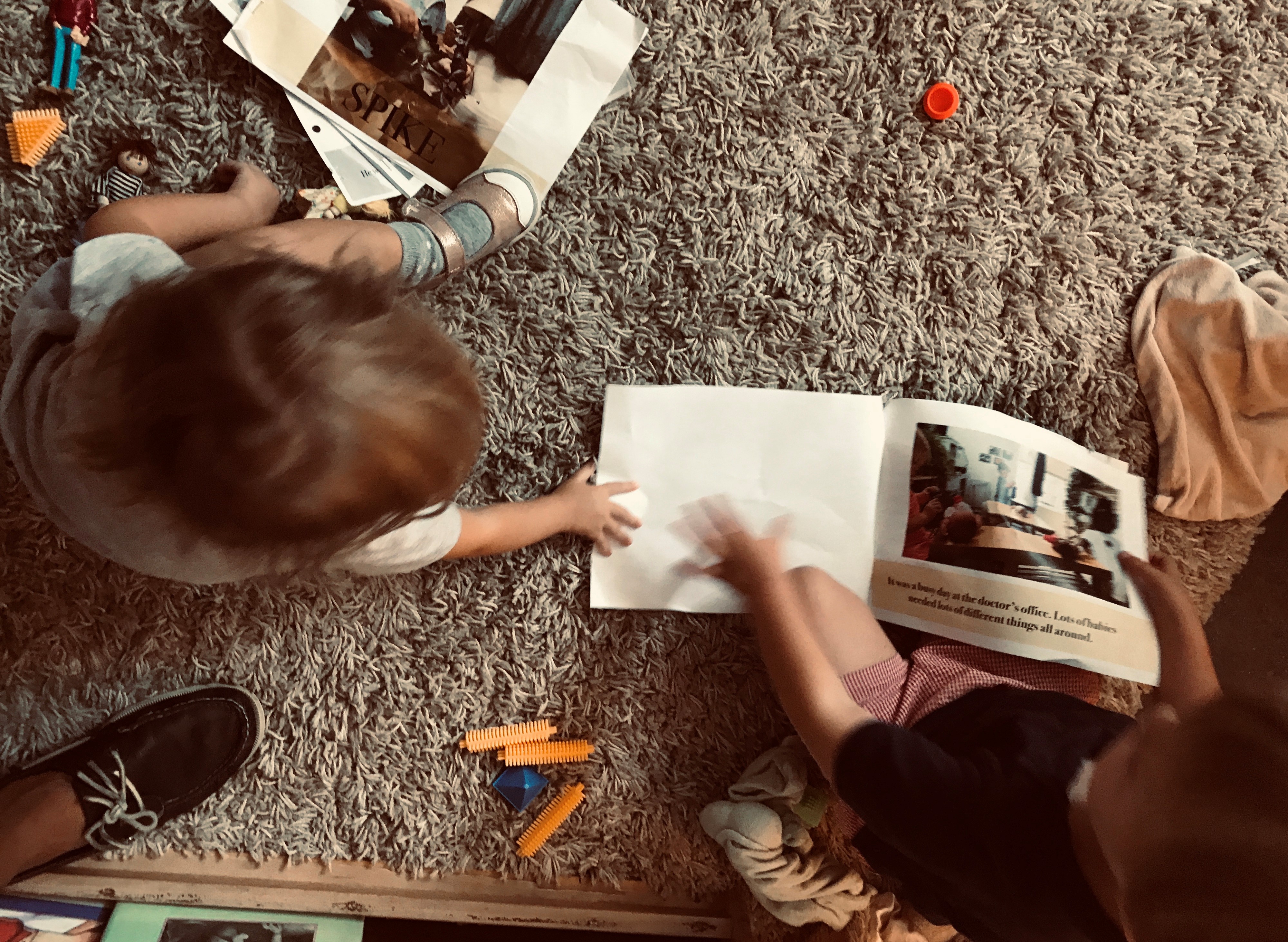 Children look at one of their class-written play stories.