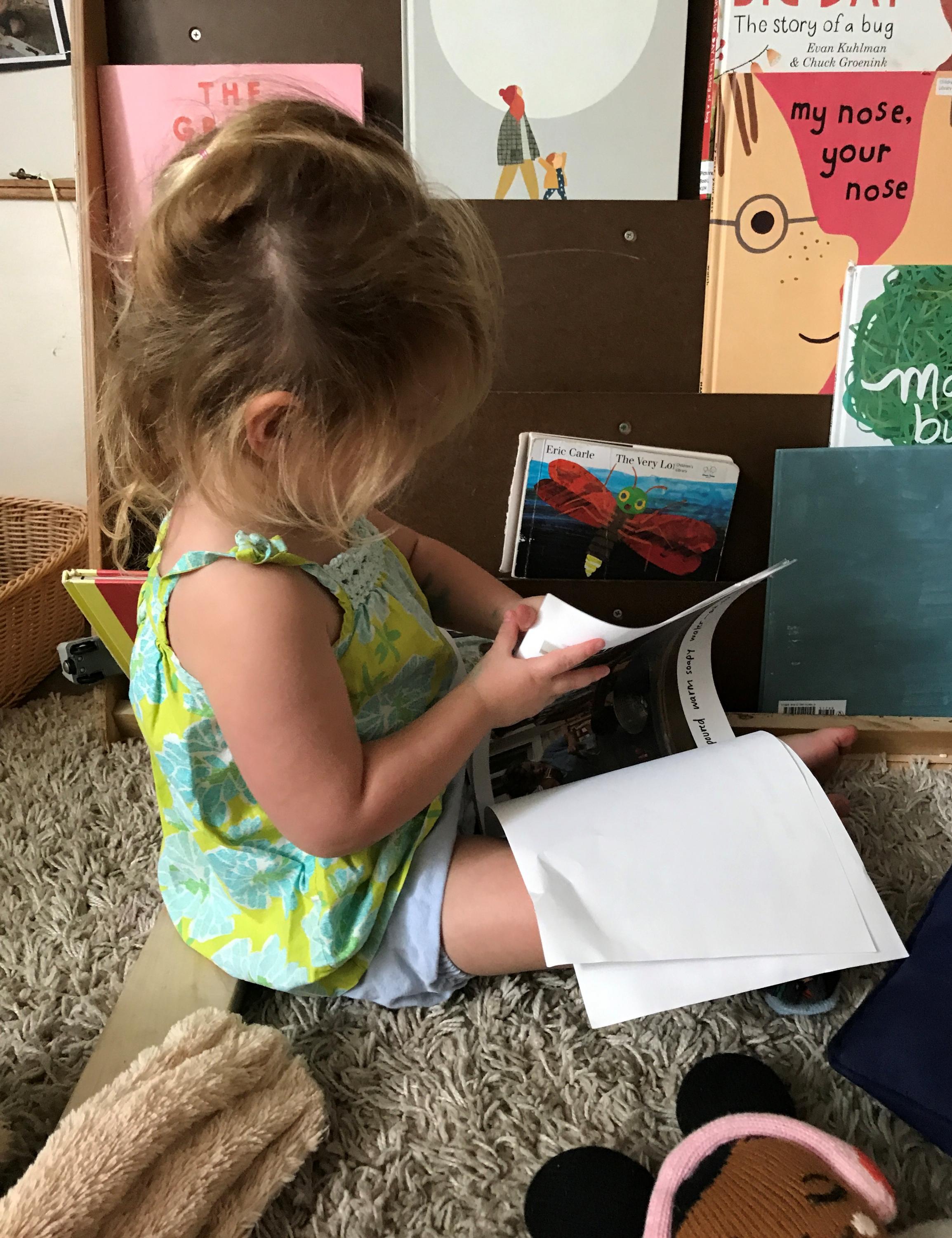 A child in Ron Grady's class interacts with one of the play story booklets.