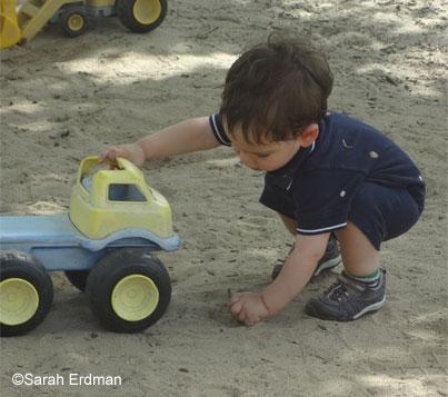 kids playing with toy trucks