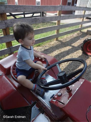 Kid playing with truck in driver seat