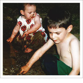 Daughter and son playing with mud together