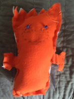 Orange stuffed animal made by third grader for a maker fest