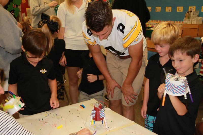 The kindergartners and their high school student partners speculated about why the machines didn’t move