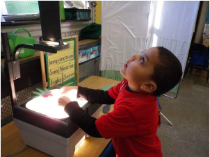 Kid playing with overhead projector