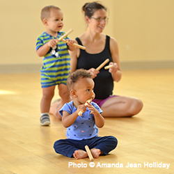 Children and parent learning how to play with musical instruments