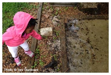 Girl playing with puddle