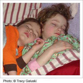 Two kids sleeping next to each other