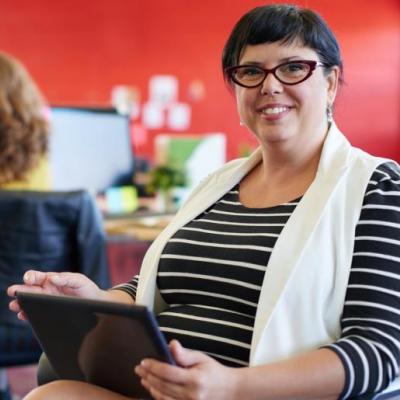 Accreditation Research Databases Woman holding electronic tablet