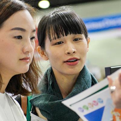 Women reviewing a book for sale