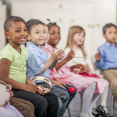 preschool students playing musical instruments