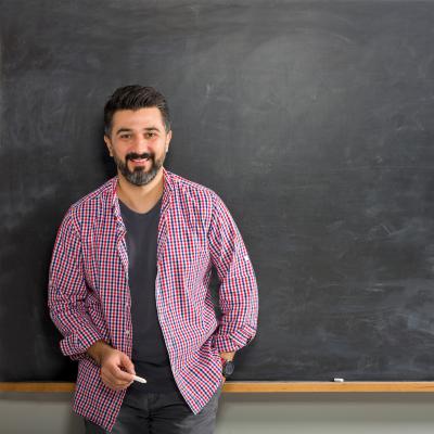 Professional Standards and Competencies for Early Childhood Educators Man with chalk standing in front of chalkboard