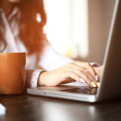Woman typing on a laptop