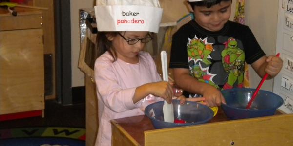 children play baking in classroom