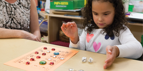 Girl playing with mathematical board game