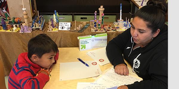 Nadia Jaboneta working with a boy at a desk