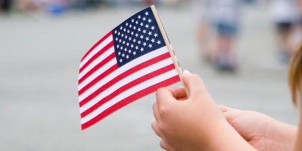 a child holding an American flag