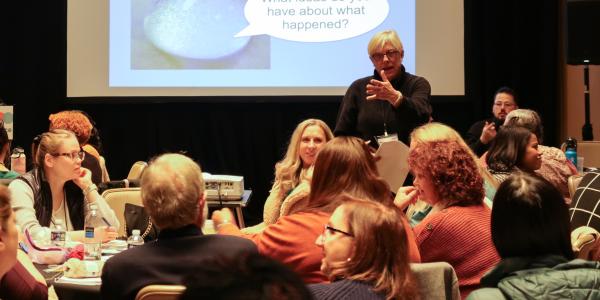 a group of professionals discussing something in a panel