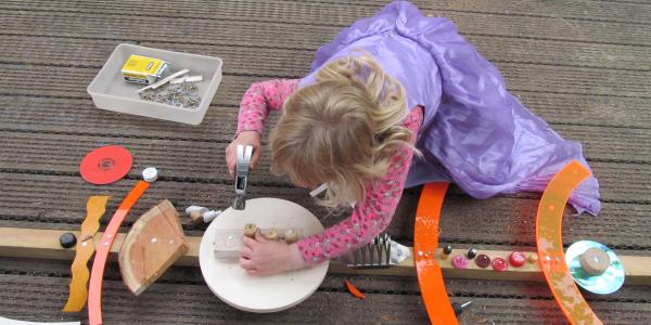 a child working on a wood-based craft