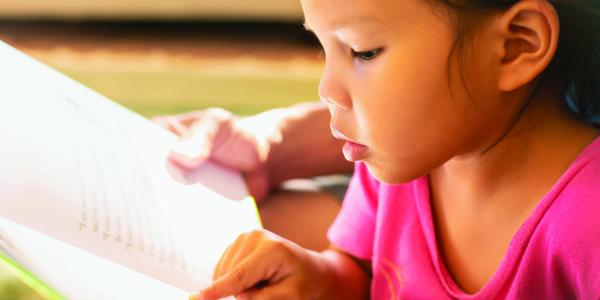 Young child learning to read