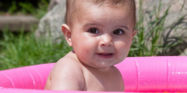 toddler in an outdoor kiddie pool