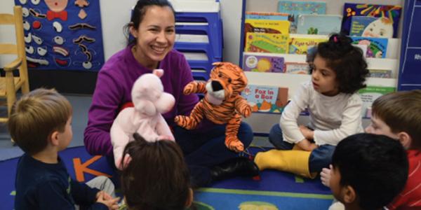 Teacher playing with stuffed animals during circle time