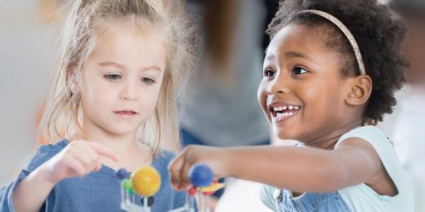 Two preschoolers playing with toy