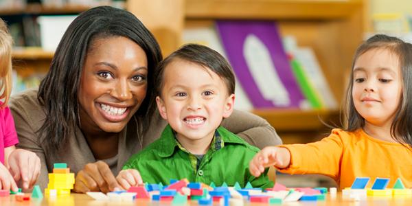 Teacher and preschooler counting blocks