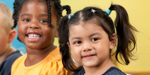 Diverse group of children in a classroom.