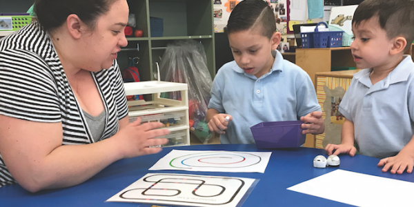 Teacher and students playing game with materials